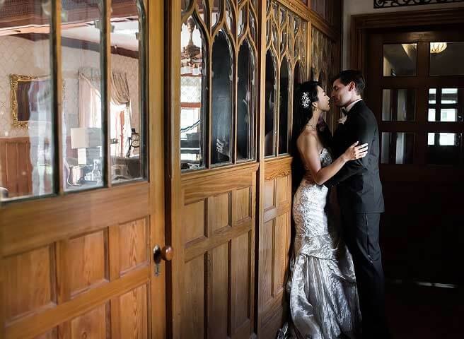 A couple embracing inside the Stetson Mansion